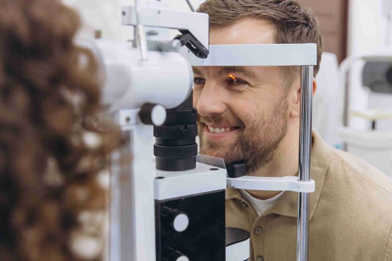 Man smiling while getting an eye examination.
